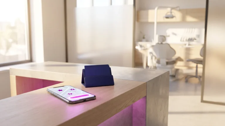 Dental marketing: phone showing a dental practice listing and booking button at the front desk